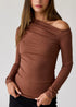 Brown off-shoulder long-sleeve top worn by a model on a plain background