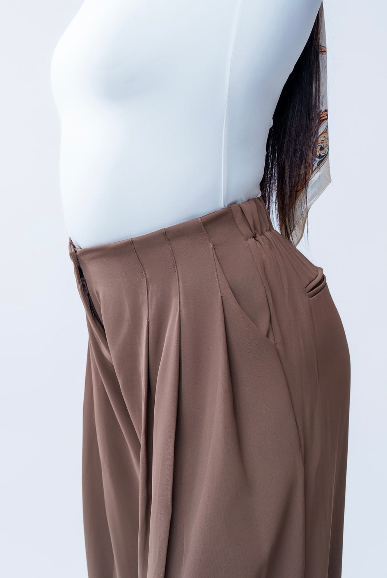 Brown pants on a mannequin against a white background