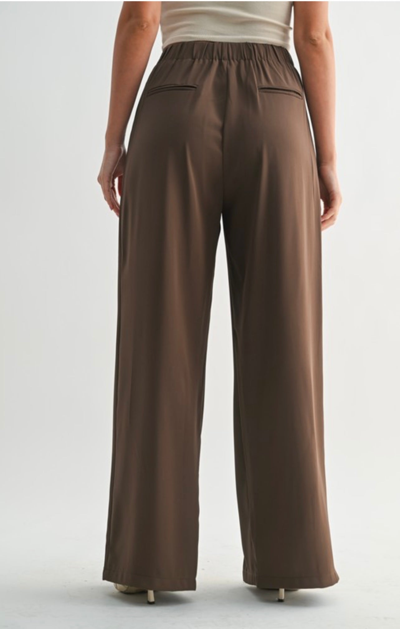Brown wide-leg pants worn by a person on a light gray background