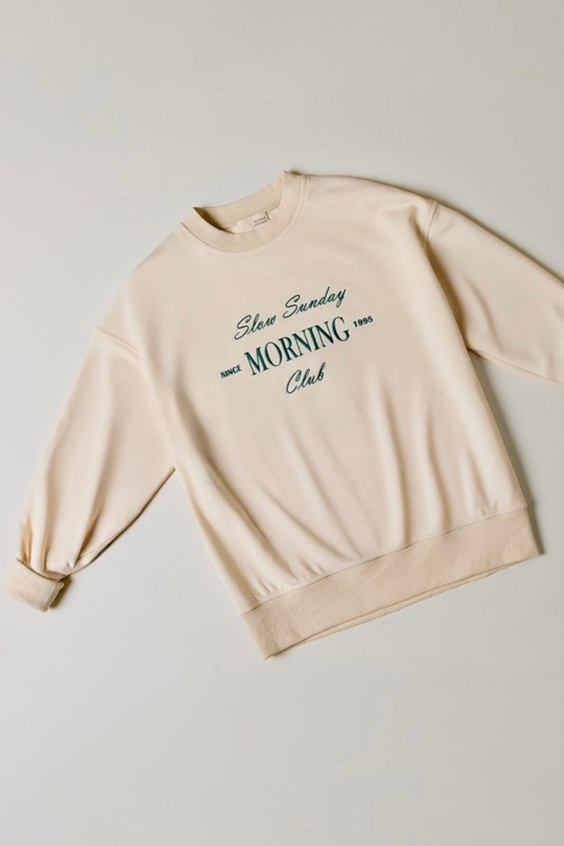 Cream sweatshirt with graphic writing on it