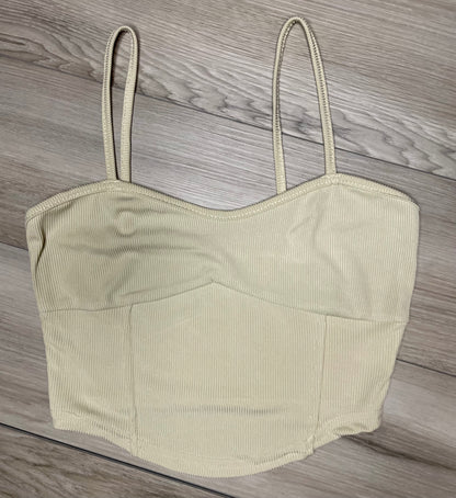 cream cropped tank top with ribbed texture  against a neutral wooden background flat. lay